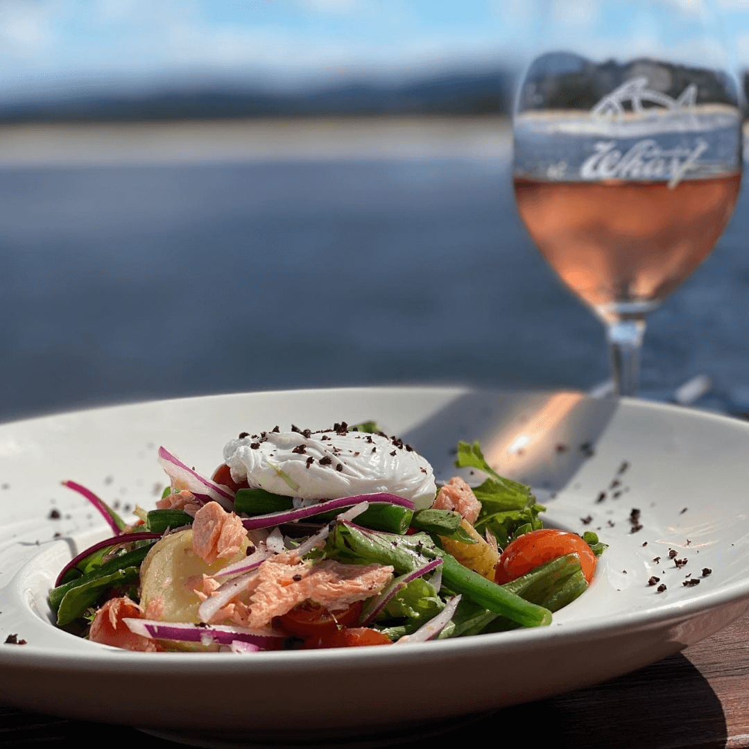 Salad and glass of rosé wine. Merimbula Restuarant